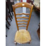 A French Cherrywood nursing chair with ladder back and rush seat