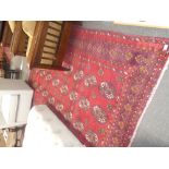 An Afghan red ground rug having elephant design 258 X 182cm