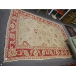 A cream and red ground rug having floral design 259 X 183cms