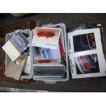 Three cartons of car brochures by Audi, Volkswagen and Mercedes Benz