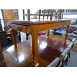 An Old stained pine kitchen table with one drawer on square legs 184cms