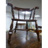 A Smokers bow armchair with turned supports with elm seat