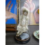 A contemporary porcelain headed doll within a Victorian glass dome 54cm high