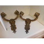 A pair of gilt cast metal two sconce wall lights