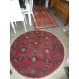 An Afghan geometric runner cut and a round rug with a pad design