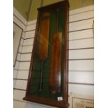 Two old cricket bats in oak display case by Gunn & Moore and Stuart Surridge