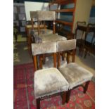 A set of six early 20th Century Gothic style oak dining chairs to include a pair of open armchairs