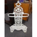 A white painted cast iron stickst and with pierced back, 62cms