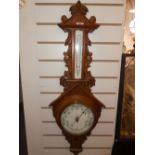 A Victorian carved oak barometer thermometer 96cms