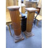 Two similar oak pedals with fluted columns on square bases, the larg 116cm