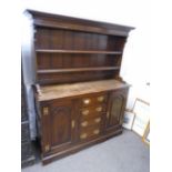 An Ipswick oak reproduction dresser and rackback having four central drawers 143.5cms