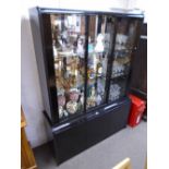 A modern Italian black glass display cabinet with cupboards below, 147.5cms