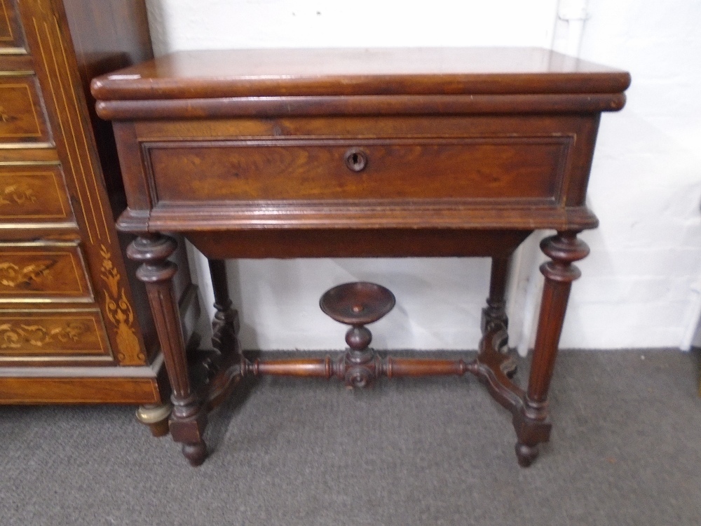 A late 19th century mahogany foldover tea table with shaped stretcher on fluted legs. 72cms