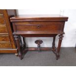 A late 19th century mahogany foldover tea table with shaped stretcher on fluted legs. 72cms