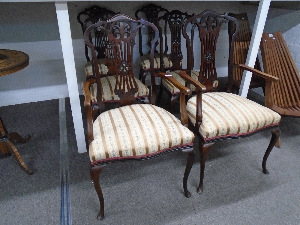 A set of 6 Edwardian mahogany saloon chairs having pierced splats on cabriolet legs