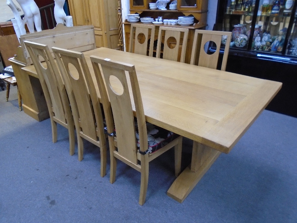 Contemporary oak refectory table and a set of six oak dining chairs by