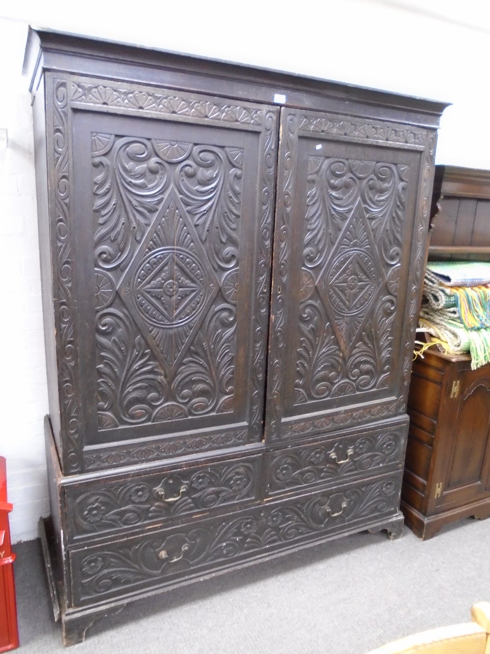 A late 19th century carved oak linen press with two short and one long drawer, 152cms