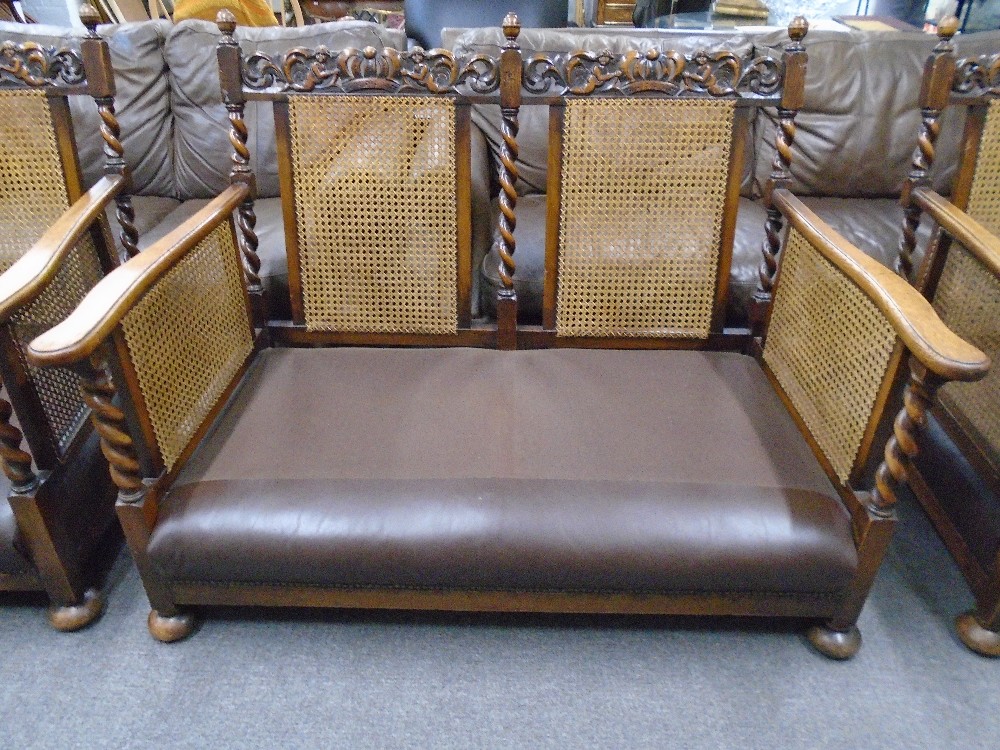 A pair of 1930's oak bergere armchairs and matching two seat settee with barley twist supports and - Image 4 of 4