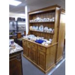 Old pine dresser with rackback, the base having three drawers with cupboards below, 152cm