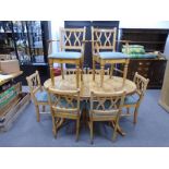 A Ducal pine oval dining table with concelled leaf and a set of eight Ducal dining chairs to include