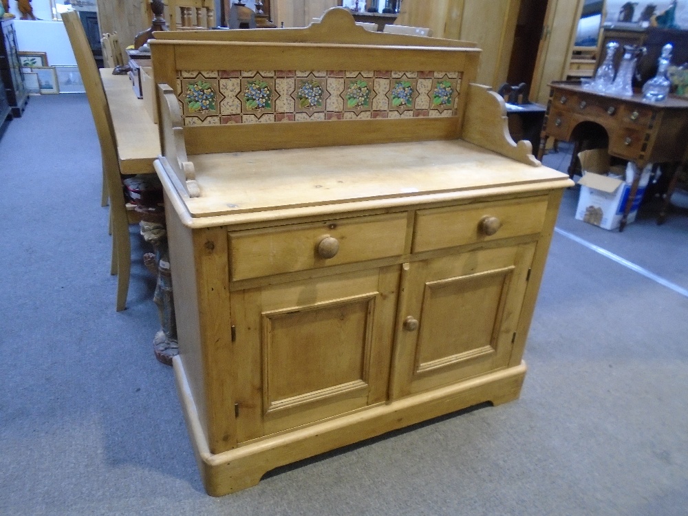 Old stripped pine wash stand having tiled back with 2 drawers and cupboards below, 104.5cm