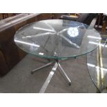 Mid 20th Century circular dining table; aluminium base with glass top. 69cm high, 110cm diameter