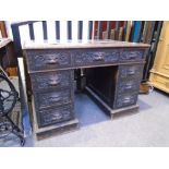 Victorian carved pussy oak twin pedastal desk having nine drawers, 107cm