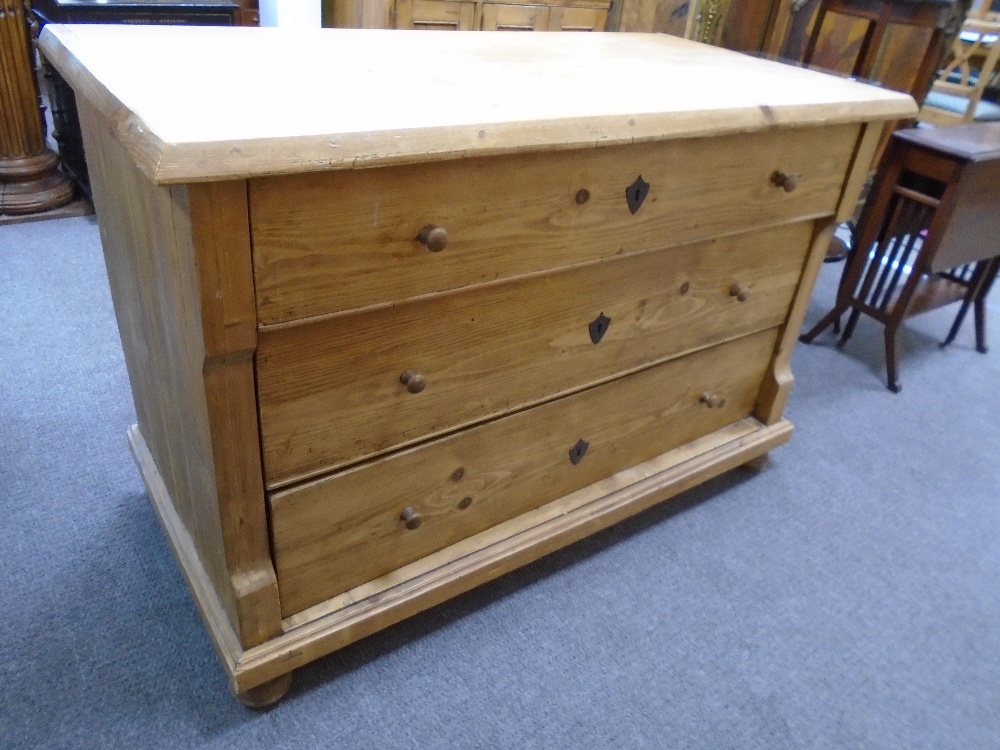 Old Continental pine ch having three long drawers on bun feet, 125cm