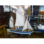 2 Models of fishing boats one with a stand