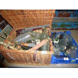 Wicker basket containing vintage bottles, decorative daggers with a small tray of vintage bottles