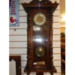 Mahogany 8 day striking clock with enamel face key and pendulum