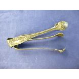 Pair of Continental white coloured metal sugar tongs with lion paw grips & a silver plated example