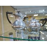 Edwardian silver tea pot and matching coffee pot, shaped edge, ebony knop and handles, each on 4