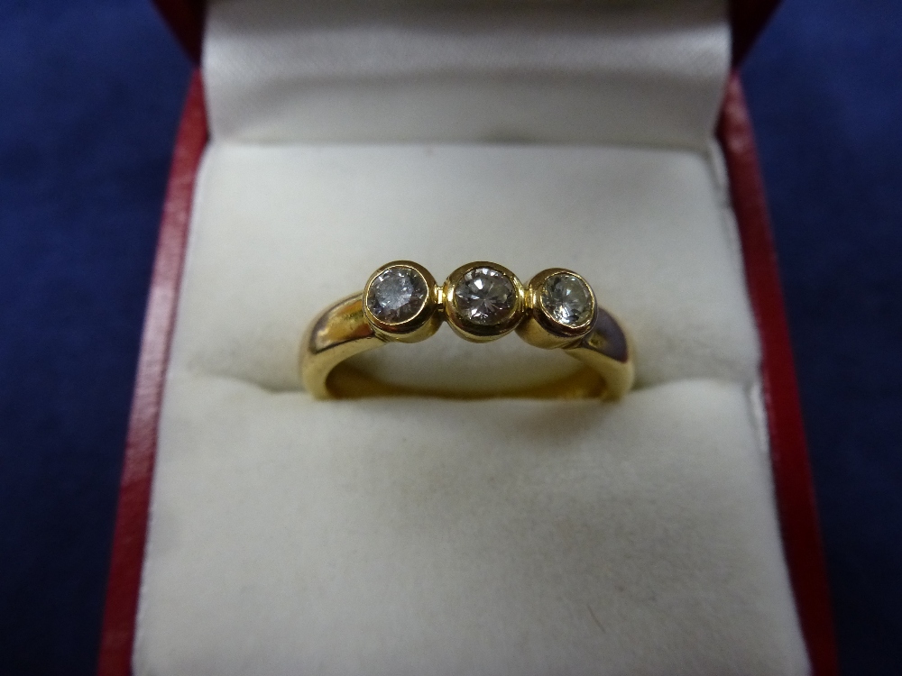 18ct yellow gold contemporary style ring set with 3 diamonds, shank stamped 750, EF Ltd, size Q,