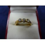 18ct yellow gold contemporary style ring set with 3 diamonds, shank stamped 750, EF Ltd, size Q,