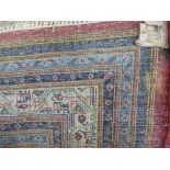 A large 20th century machine woven Iranian carpet decorated repeated design in a red field. 420 X