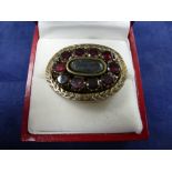 19th Century rose coloured metal oval mourning brooch set with 10 rubies, unmarked gross item weight