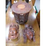 Two similar 20th Century Chinese carved hardwood masks and a small Indian carved folding table