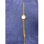 Ladys vintage Roamer wristwatch on a 9ct yellow gold articulated strap stamped 375, total gross item