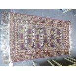 A 20th century machine woven rug having repeated design lines of decoration 142 X 88cms.