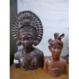 Two African carved wooden busts, the larg 34.5cms