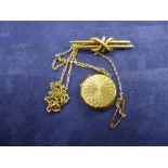 15ct yellow gold bar brooch, stamped 15ct approx. 3g together with a 9ct rolled gold circular locket