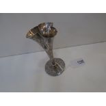 Antique white coloured metal triform vase on circular base, engraved figural decoration, flowers and
