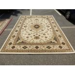 A modern Turkish Tabiz style carpet having floral design in a cream field 330 X 240cms