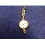 Ladys early 20th Century wristwatch with white enamel dial 9ct rose gold case and expanding wrist
