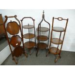 Two Edwardian mahogany three tier cakands and two others