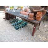 An old oak work bench having cast iron supports formerly used for bicycle repairs 205cms