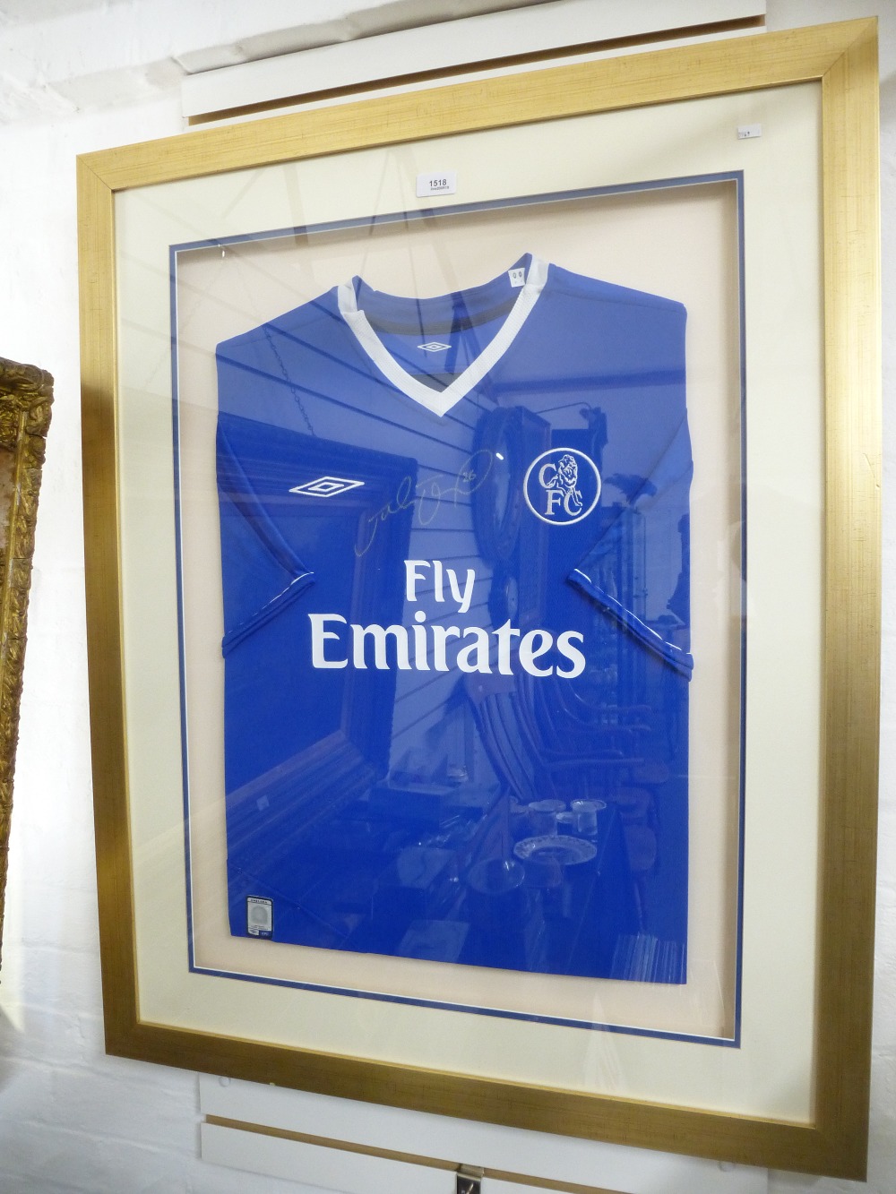 A Chelsea football home shirt hand signed by John Terry, framed and glazed with certificate.