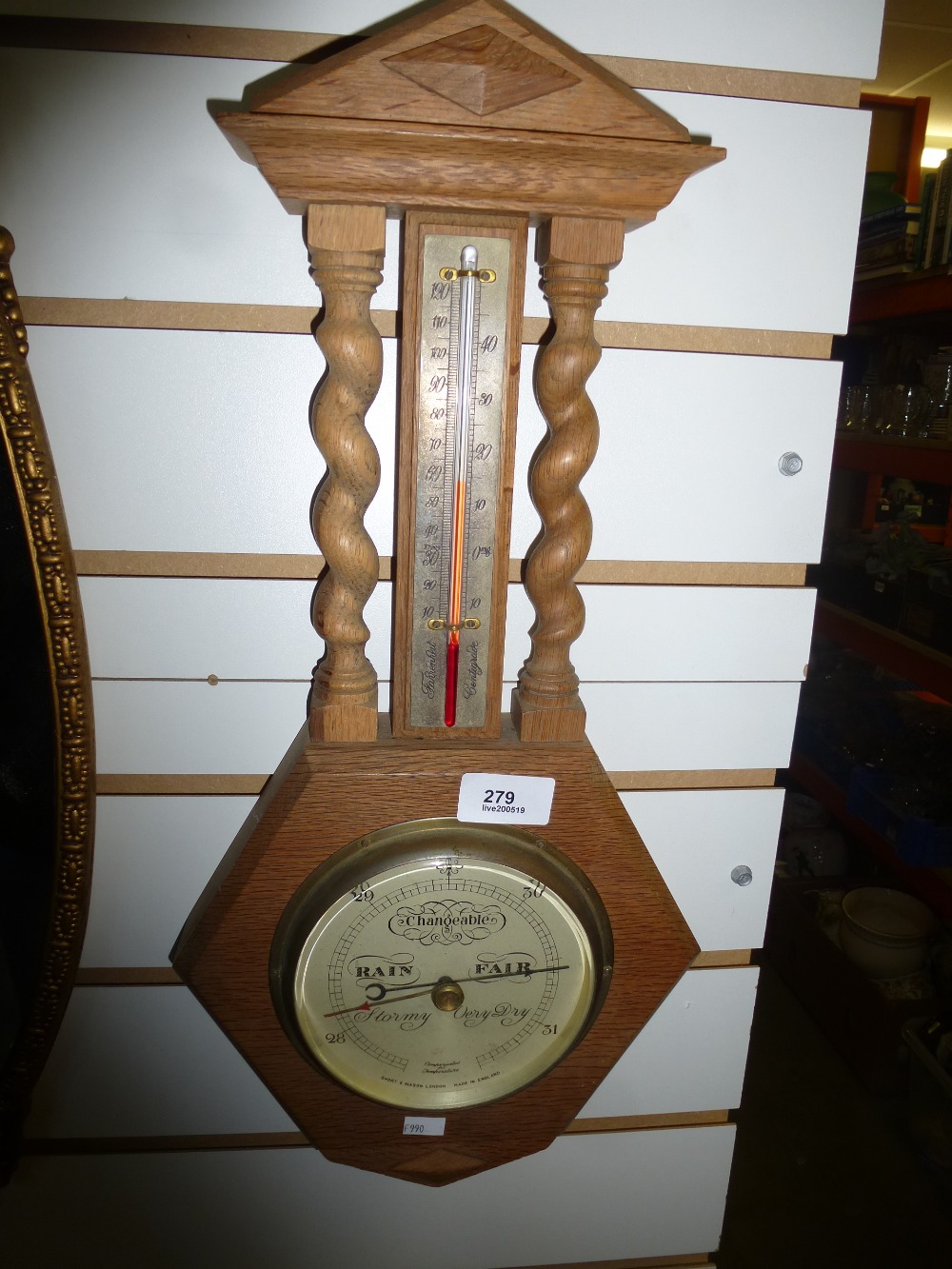 An Oak hanging barometer with twisted column detail