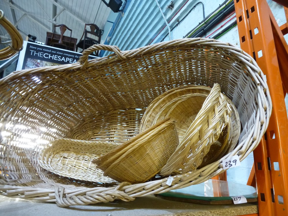 Wicker crib with other wicker items, wall mirror and a rug